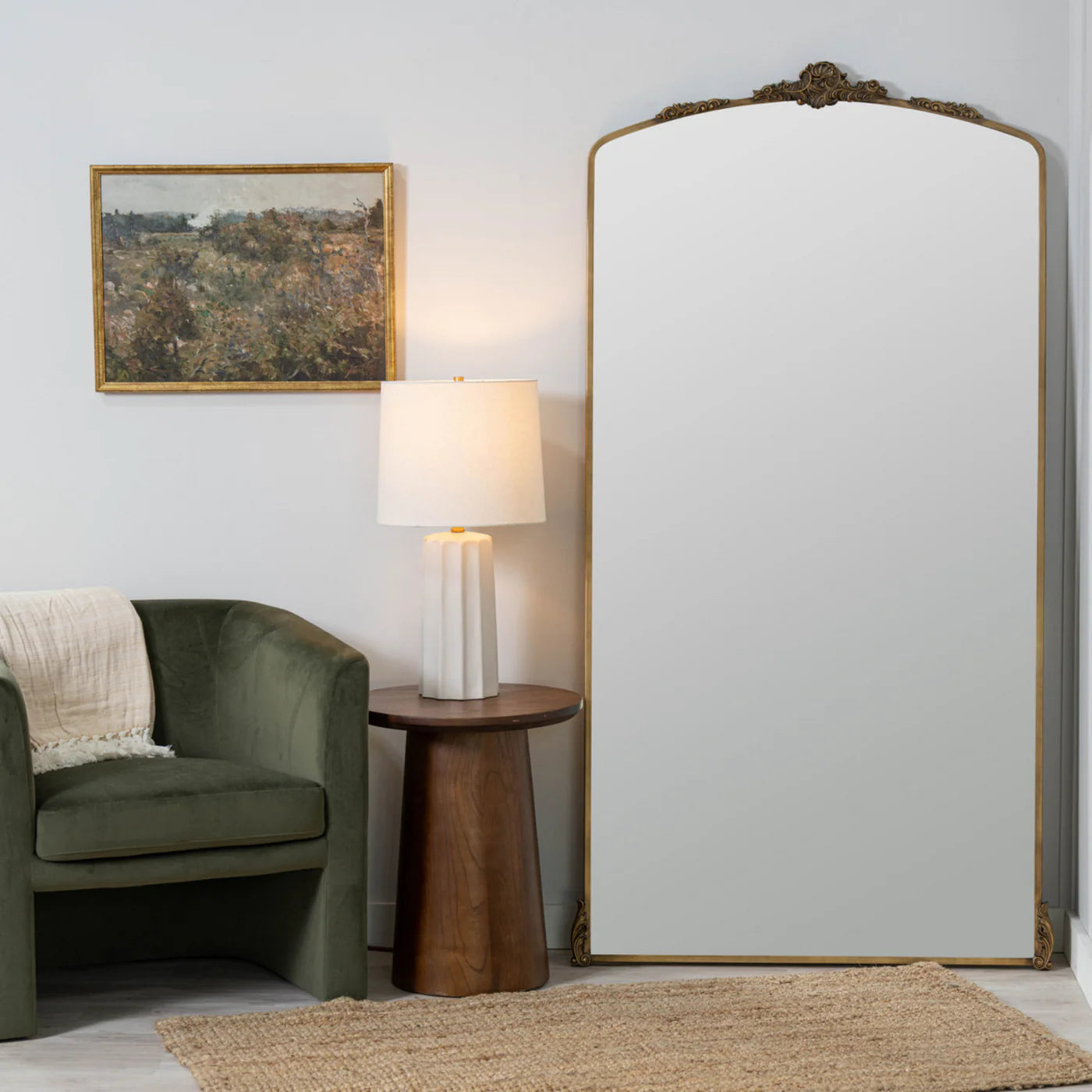 Arched floor mirror with antique look and brass finish that has a classic charm.