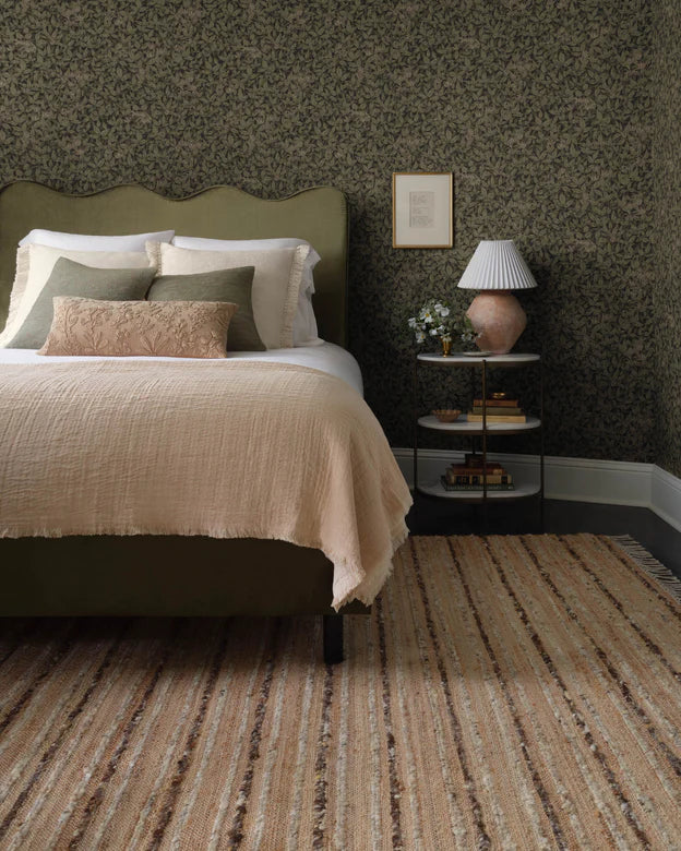 a dynamic jute rug with raised, alternating lines of wool and cotton, finished with playful fringe. Neutral, undyed tones give the rug an organic modern feel that can ground living rooms, bedrooms, dining rooms, and more. 