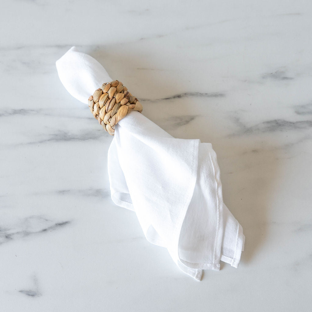 White linen napkin with seagrass napkin ring