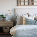 Oatmeal linen double sided pillow covers on bed with cool neutrals